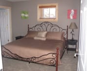 Lower level guest room with a king size bed