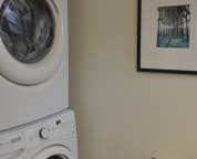 Full size washer & dryer located in 1/2 bath off foyer.
