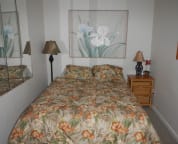 Sleeping den with queen sized bed and alternate quilt.