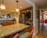 Fully equipped kitchen with stainless steel appliances, granite counters
