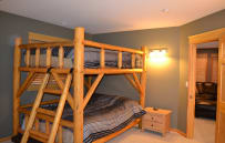 One of two queen bunk beds in basement.