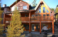 Exterior with larch. Hot tub on upper back deck.