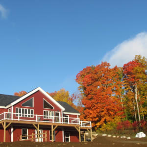 The house is a reverse gable design with a wrap around deck