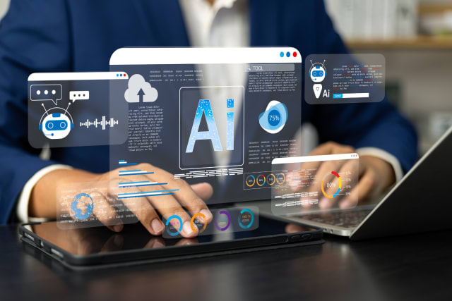 Image depicts someone sitting with a tablet and laptop and AI graphics overlaid that look like computer screens.