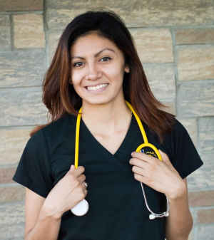 A female medical student holds her stethoscope around her neck