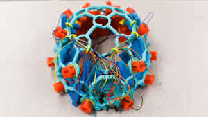 A student project of blue and orange electrodes, plastic framing and wires