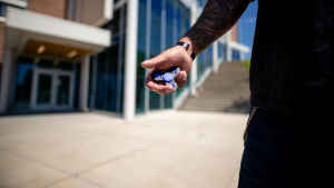 A veteran holds a fidget spinner in his right palm, which he uses when he is feeling anxious. 