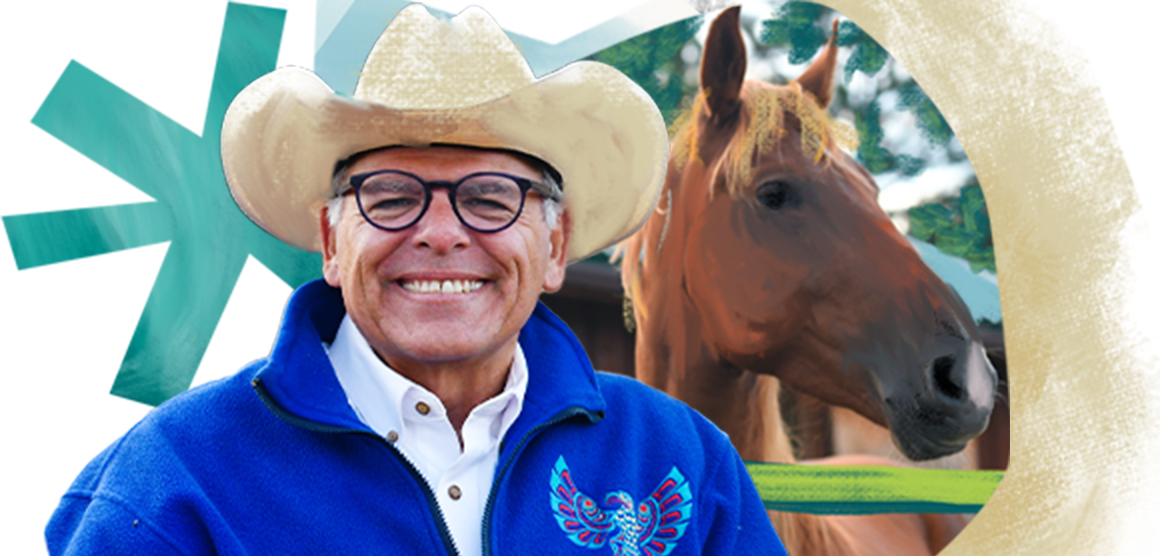 A man smiles broadly while wearig a cowboy hat, eyeglasses, and a bright blue fleece with a Native American bird symbol on it. The background is an artistic design with a brown horse depicted and colorful shapes