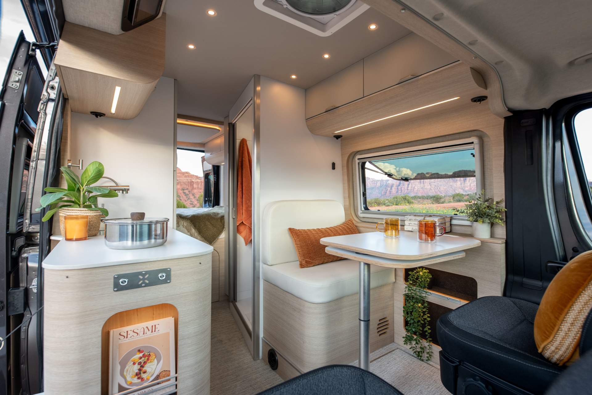 Noovo Lite camper van parked on a gravel road at the edge of a forest