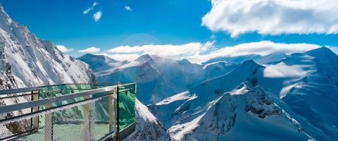 Glass observation platform on top of Kitzsteinhorn mountain in Kaprun, offering a breathtaking view of the snowy Alps.