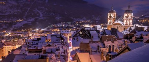 Night view of illuminated buildings and church in Serre Chevalier