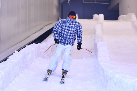 Person skiing indoors on an artificial snow slope
