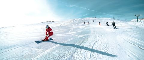 Ski school instructor teaching at a top resort for lessons