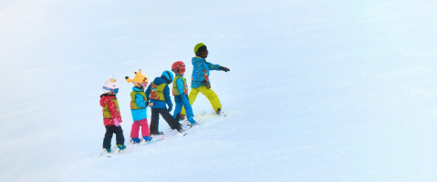 Young child learning to ski on a family ski holiday