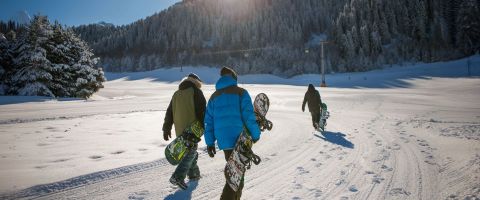 Skiers on a mountain illustrating what a ski holiday costs