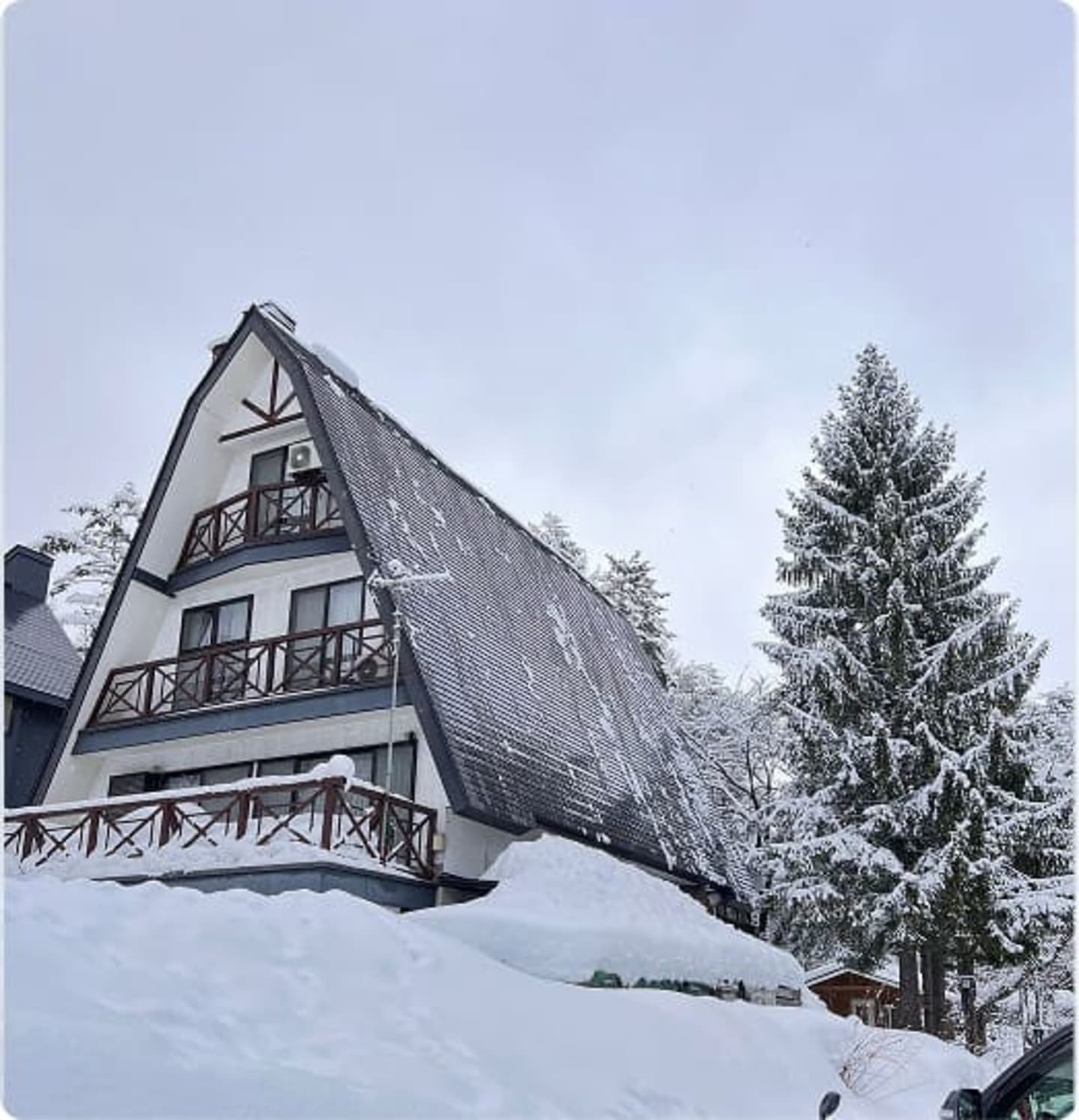 Traditional A-frame Japanese ski chalet covered in snow
