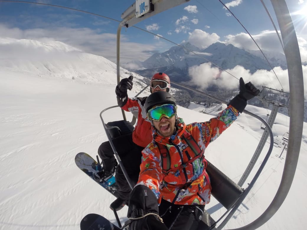 Dan Benavi on the chairlift in Tignes with the pistes behind him