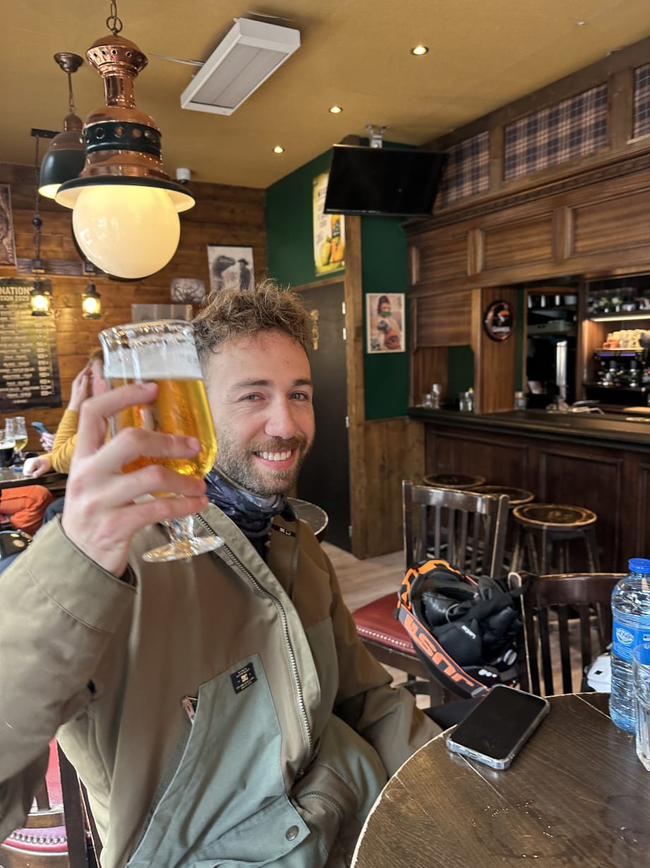 Raising a glass of beer in a wood-panelled mountain bar in Les Arcs