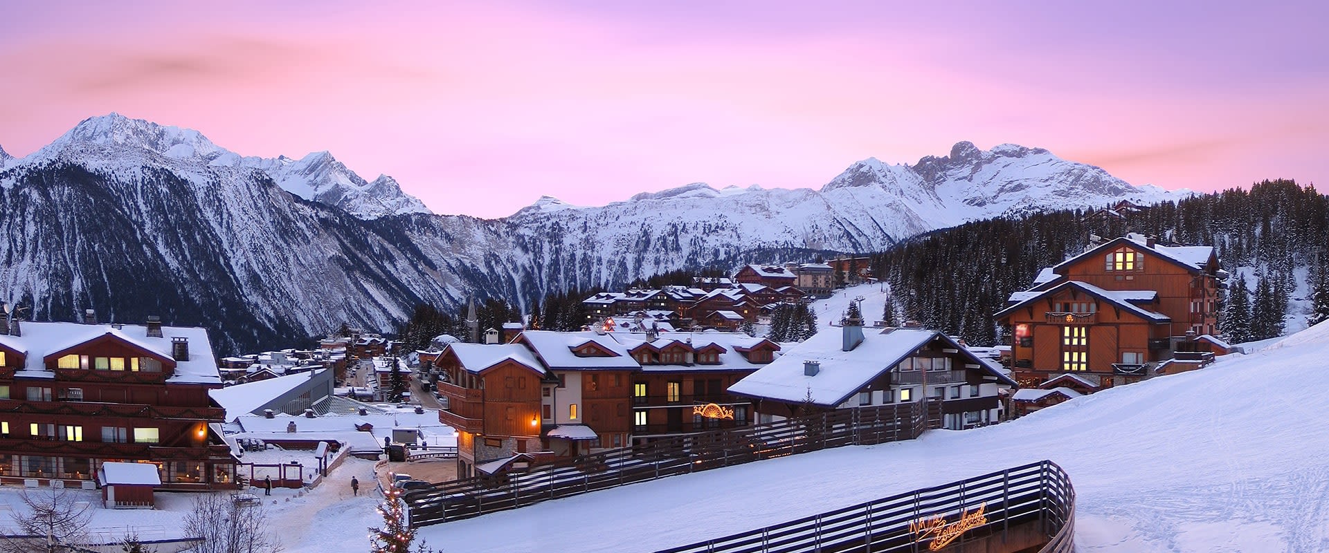 View of Courchevel chalets at night in winter