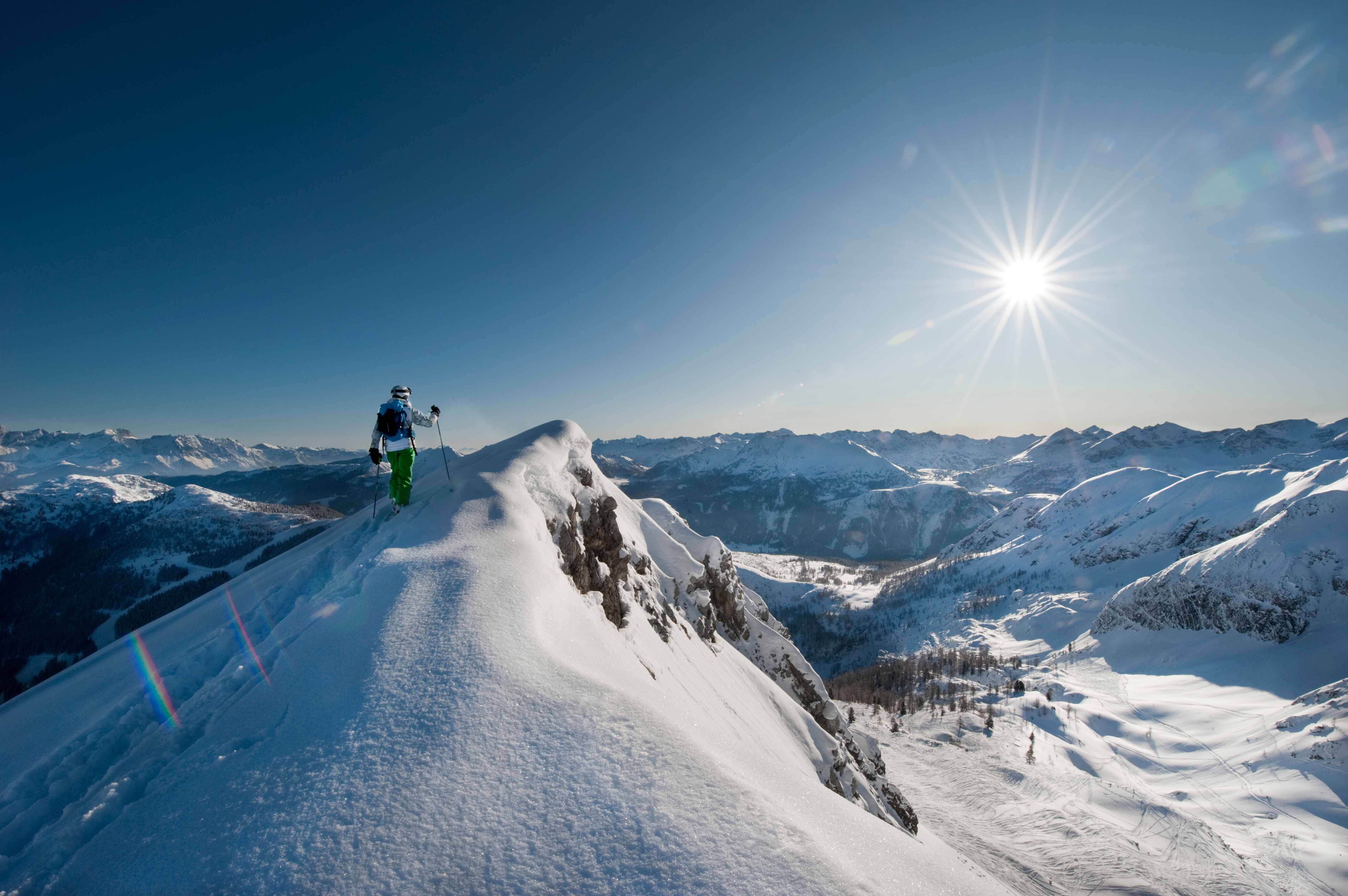 Salzburg Austria woman skiing under a blue sky