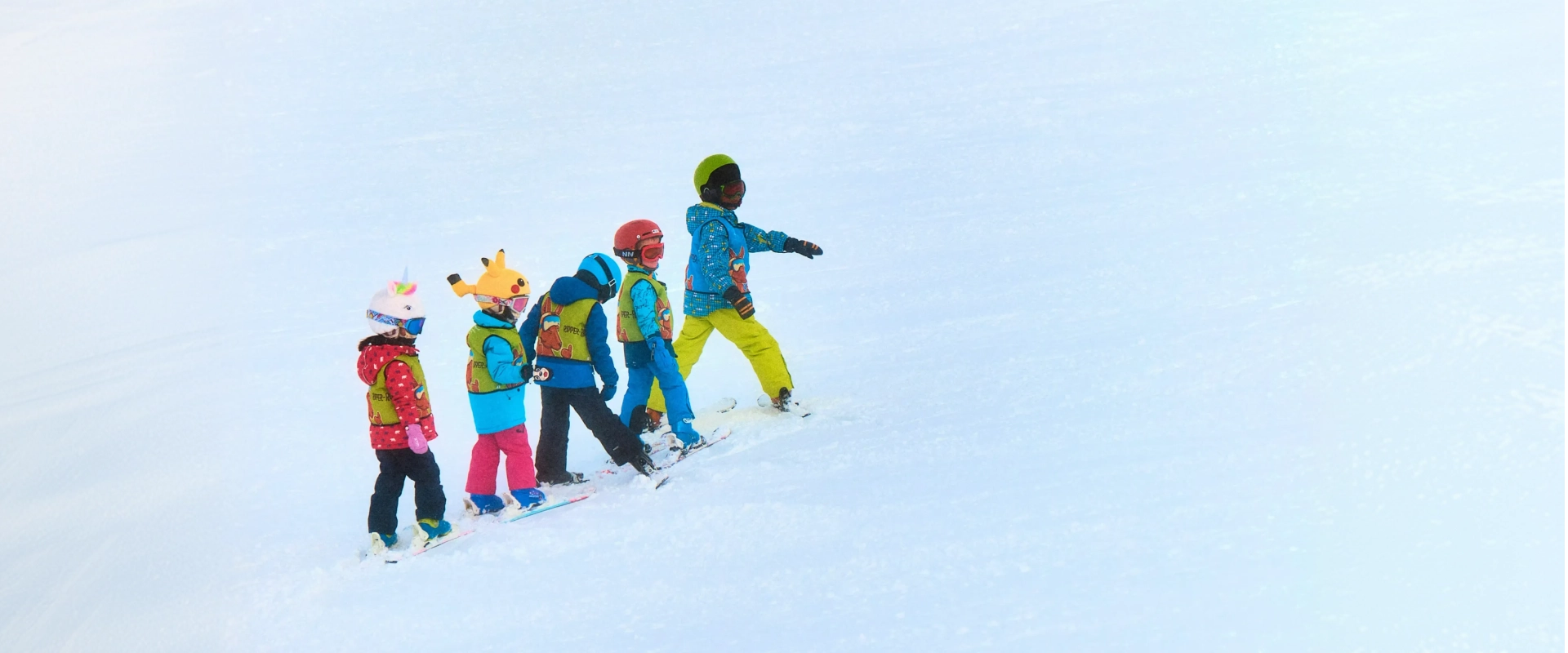 Young child learning to ski on a family ski holiday