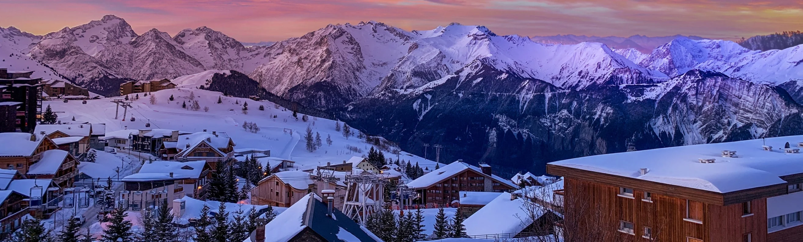 Chamonix ski resort with a snow-covered village and mountain backdrop during sunset