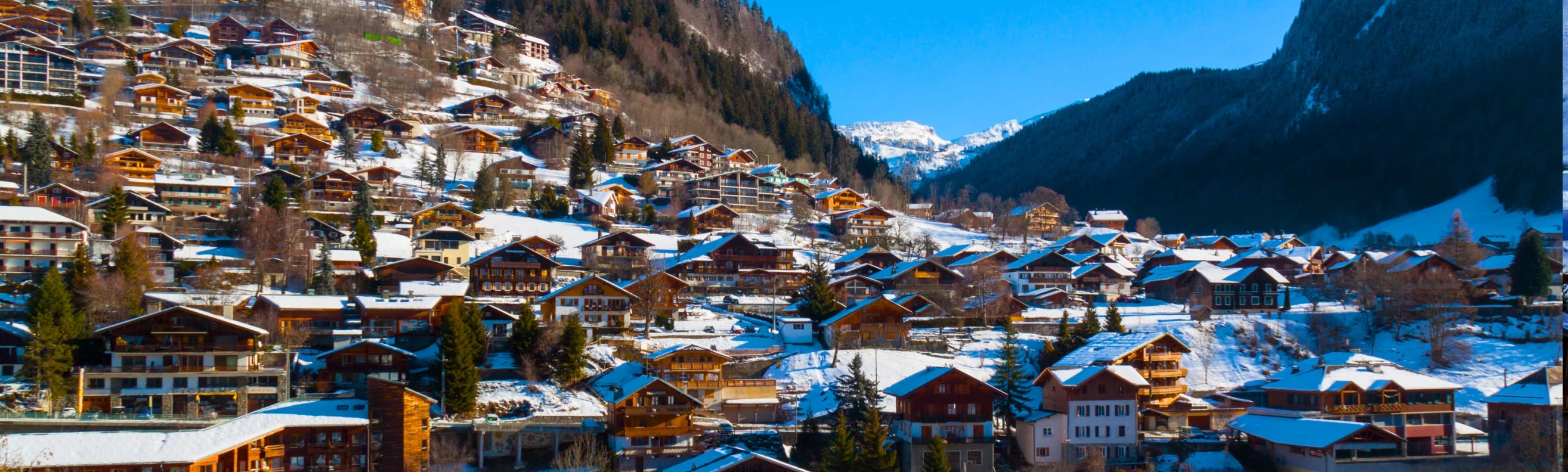 Village of Morzine with traditional chalets scattered across the snow-covered hillside