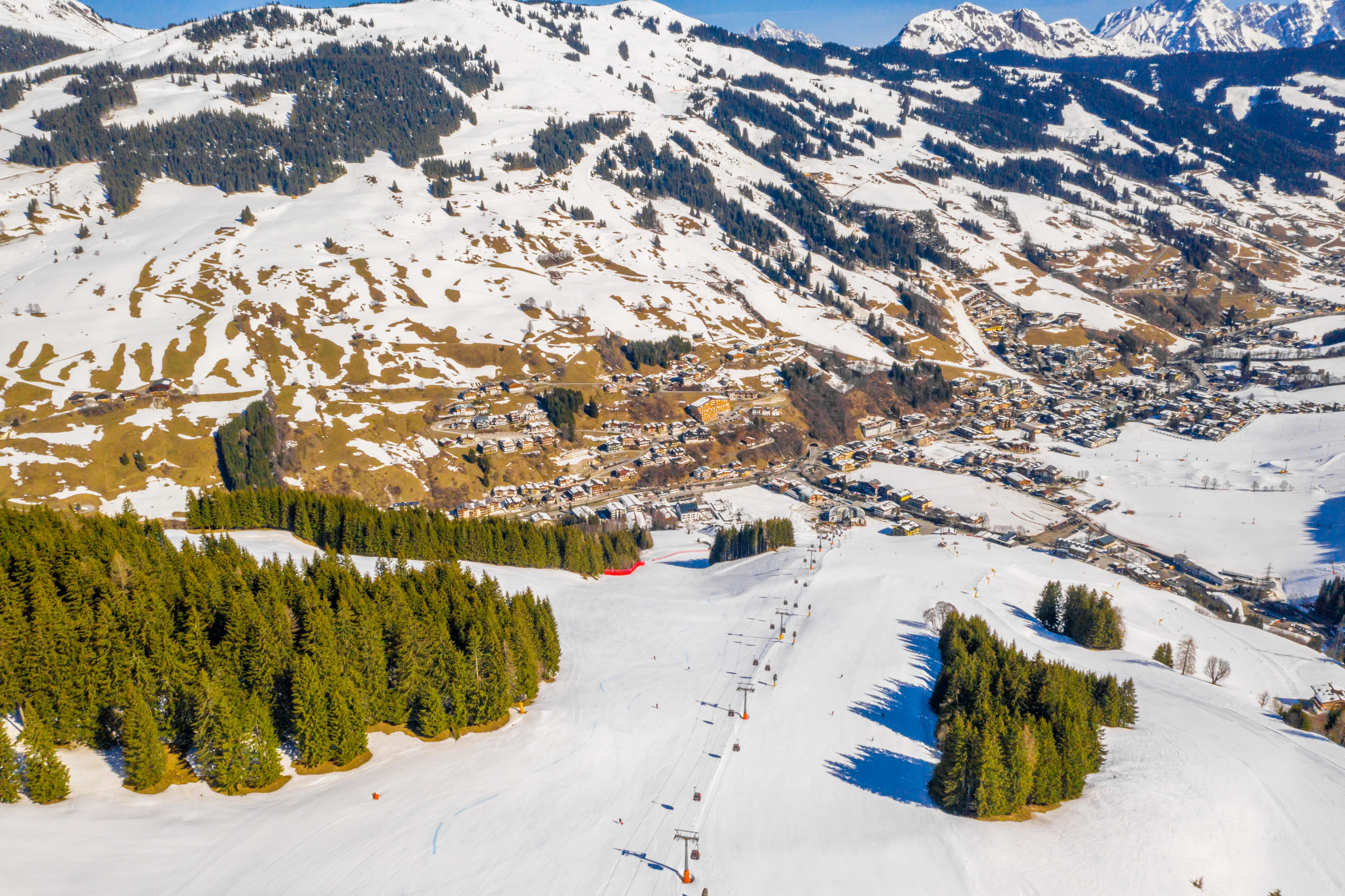 High-angle view of a ski resort partially covered in snow