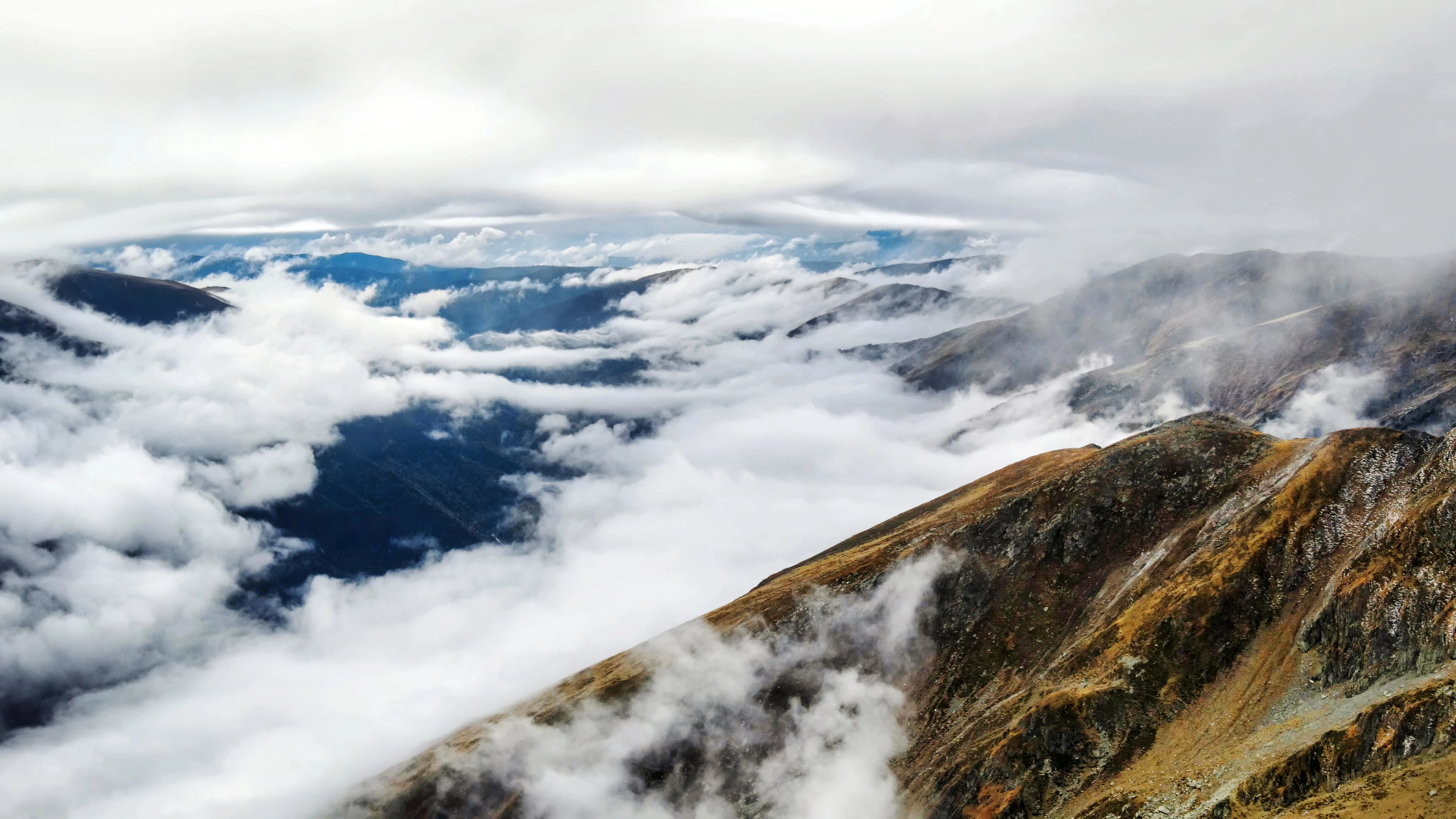 Mountain peaks covered by clouds