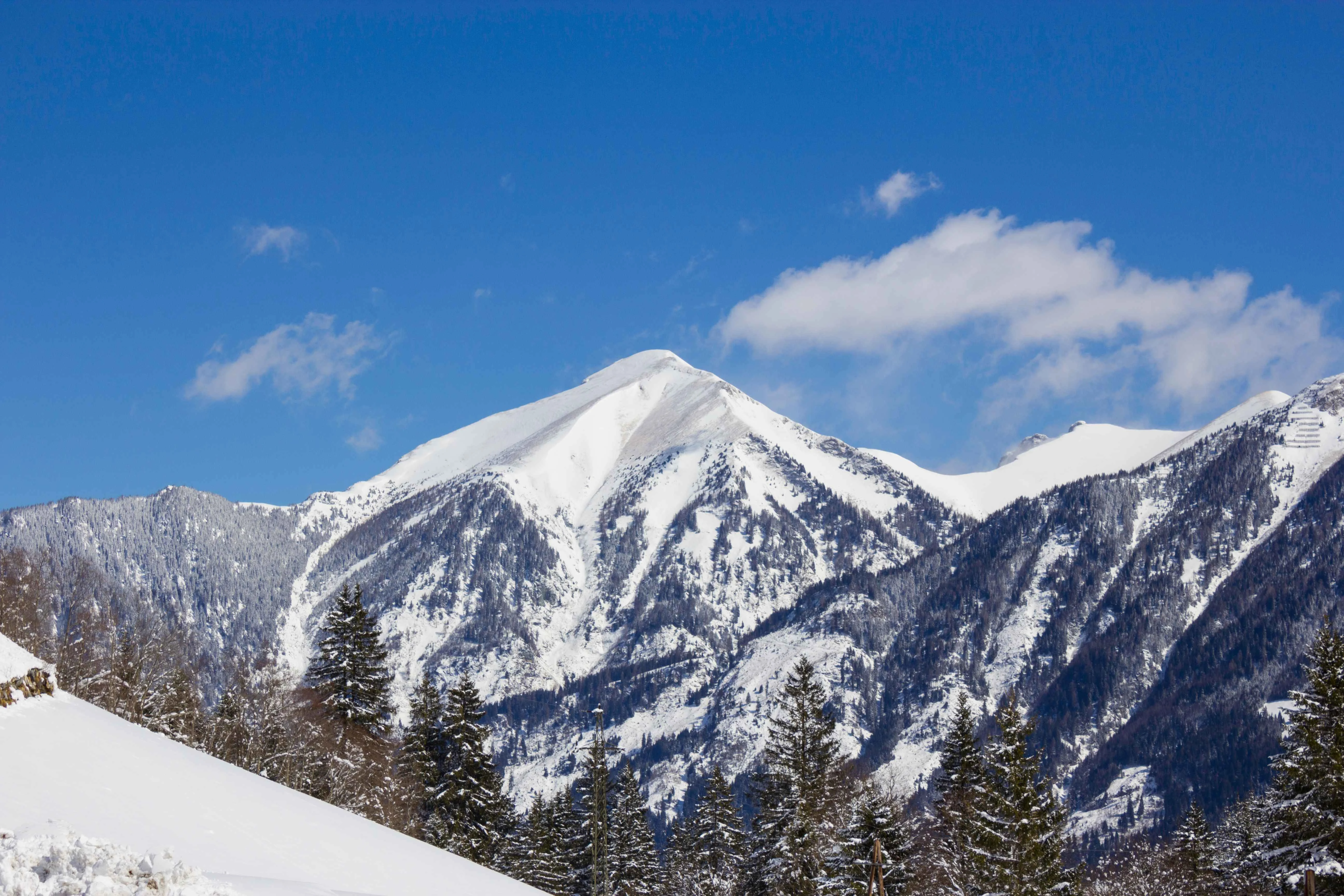 Rauris ski resort mountains in winter under a blue sky