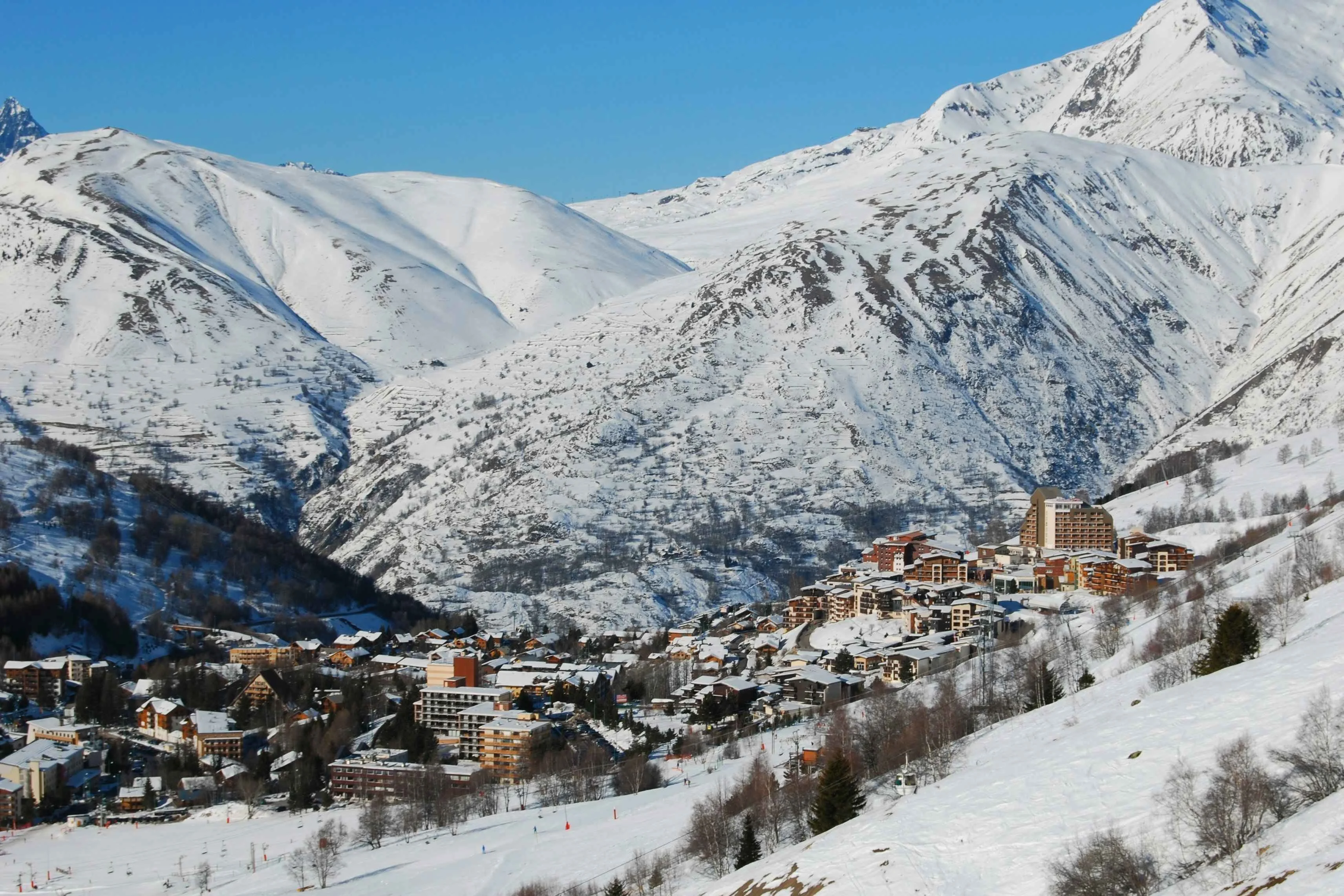 ski resort in a snowy valley under a winter sunshine day 