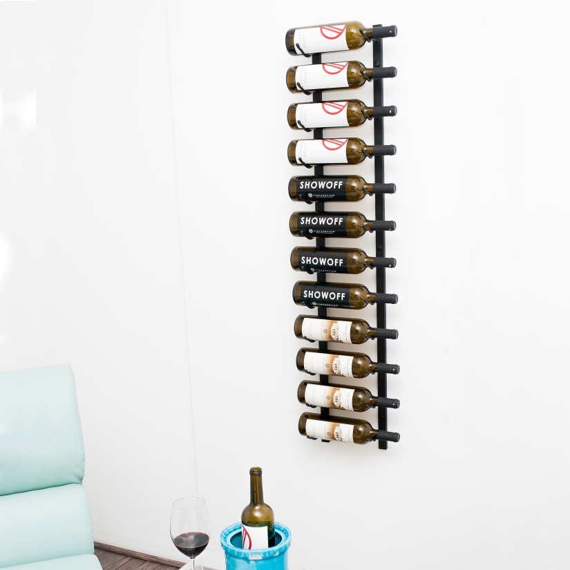 Vertical wine rack holding several bottles mounted on wall
