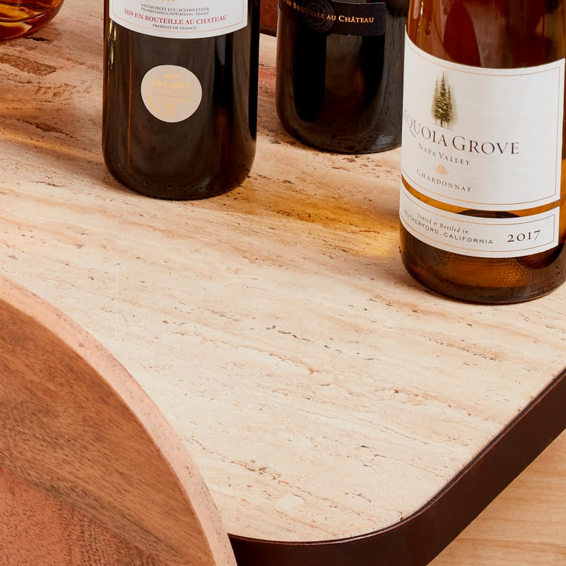 Wooden wine bottles on a marble-like bar surface