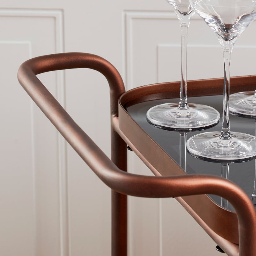 Copper bar cart handle with glasses on top
