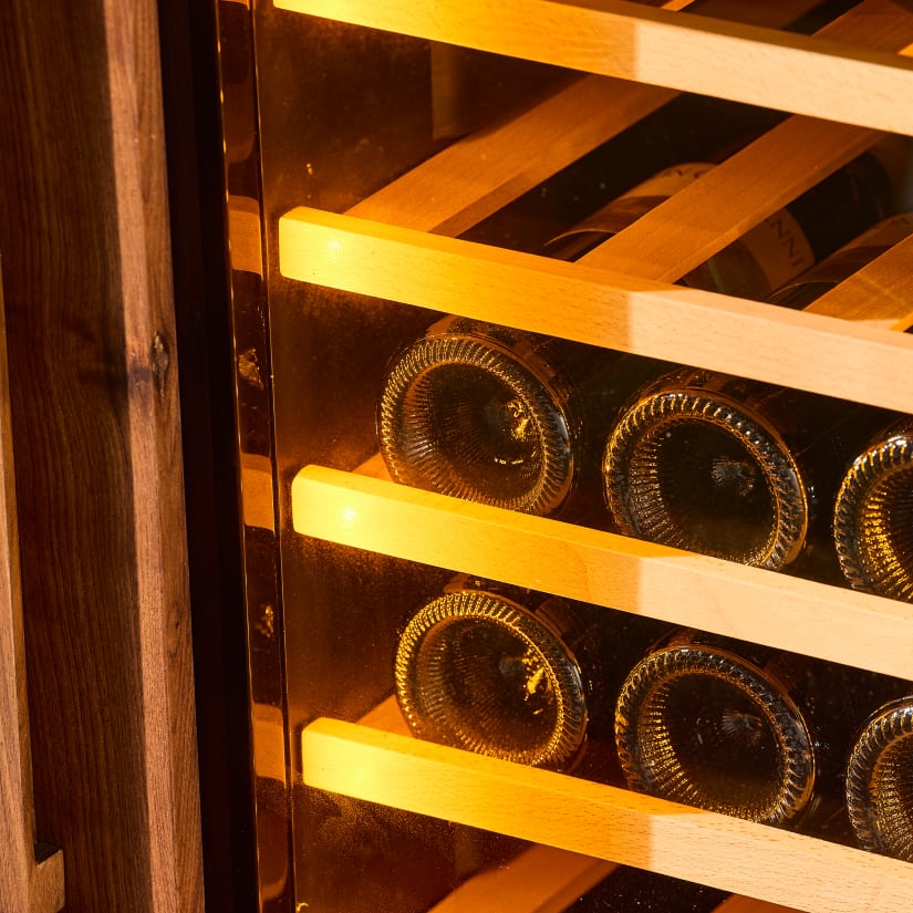 Close-up of wine bottle racks inside the sideboard