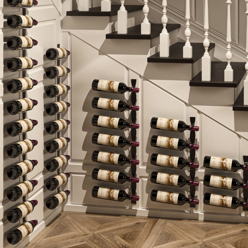 Wine rack on staircase wall displaying several bottles