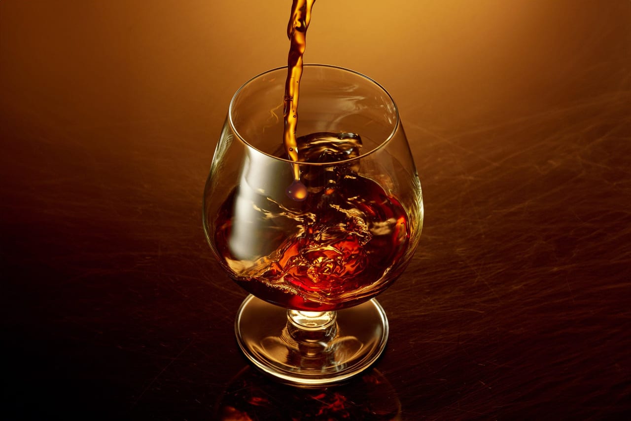 glass of brandy on a warm toned surface