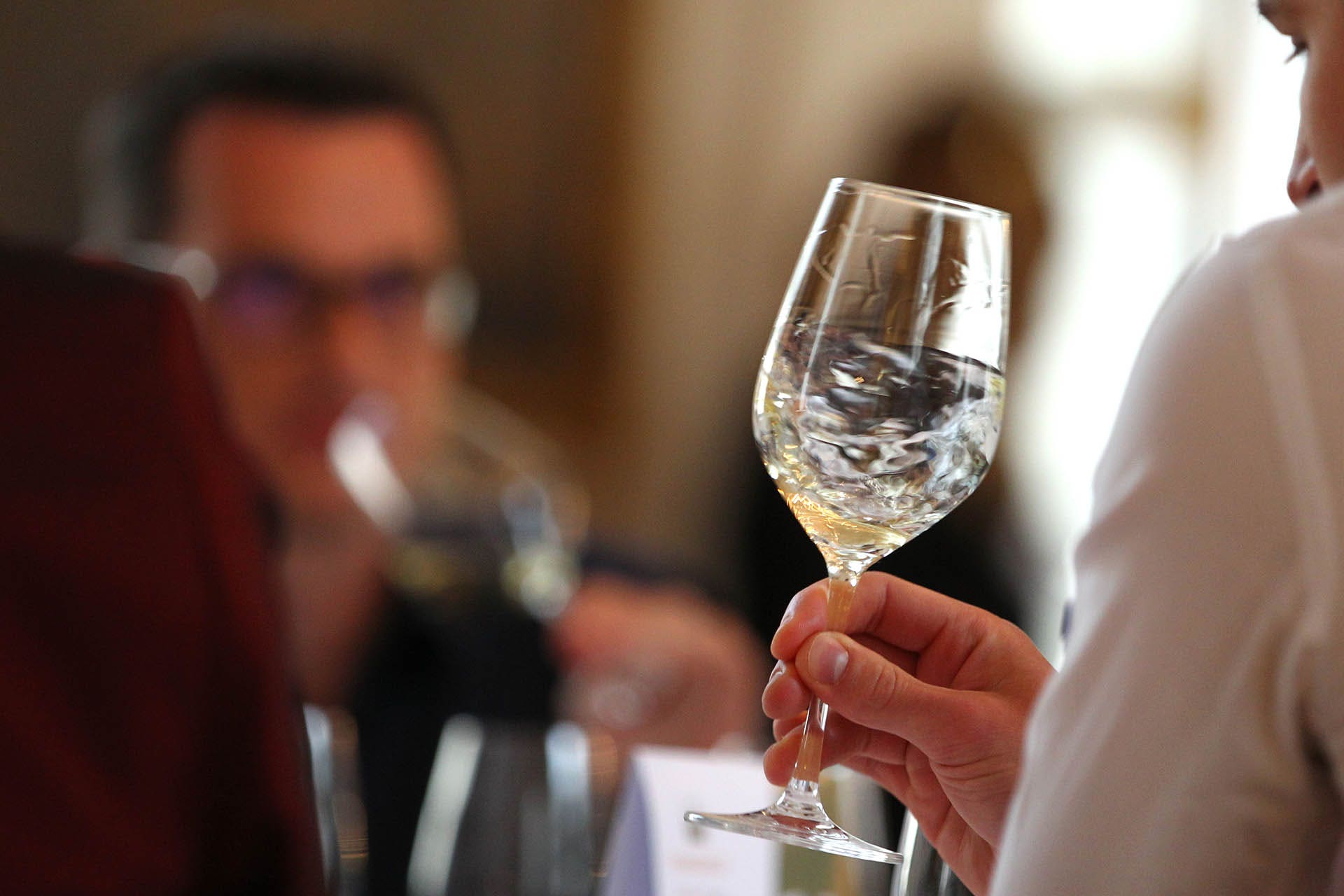 A juror swirls a glass of wine during the competition 'Best of Gold' in Wuerzburg, Germany, 11 May 2015. A jury elects the best wines from Franconia in the competition. Photo: Karl-Josef Hildenbrand /dpa | usage worldwide (Photo by Karl-Josef Hildenbrand/picture alliance via Getty Images)