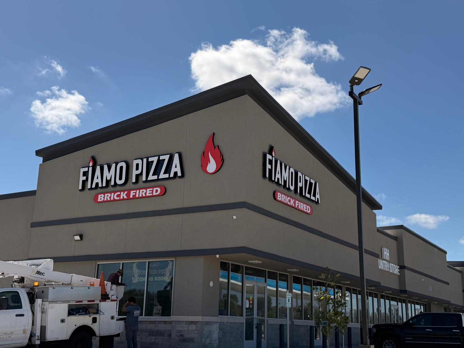Corner restaurant storefront signage with dual-facing visibility
