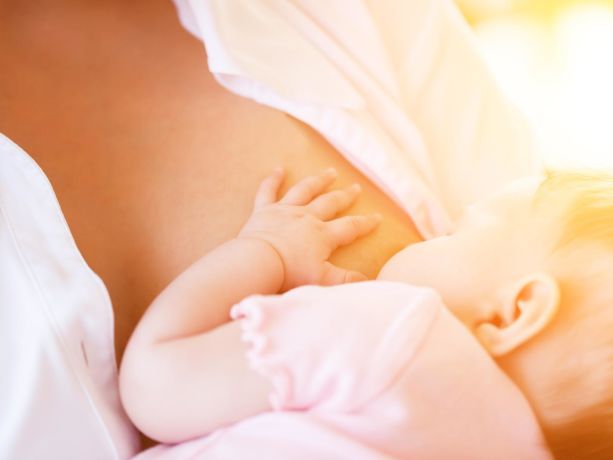 bir anne yeni doğan bebeğini emziriyor