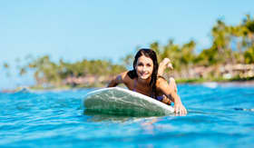 Hawaii Cruisetours, Woman Surfing in Hawaii, Paddling out to the Lineup