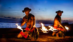 Holland America Line hawaiian men preparing to dance with fire in Maui