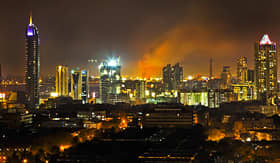 Regent Seven Seas Cruises Bombay India Bandra Station ablaze with plumage of flames and smoke high into the night sky