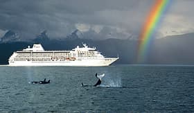 Regent Seven Seas Cruises Seven Seas Mariner with rainbow and Orca whales