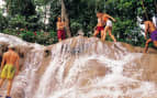 Guests enjoy playing on Jamaican waterfalls