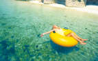 Woman relaxing in inner tube in the Caribbean