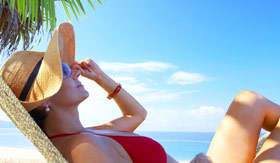 Woman relaxing on beach by herself