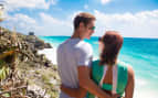 A young couple enjoys the cliffs of Tulum, Mexico