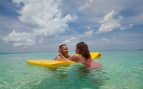 Couple enjoys relaxing on a raft in the Caribbean