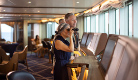 Guests enjoying the view from the Bow Lounge on Seabourn Pursuit